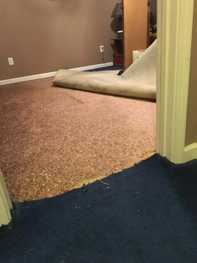 Carpet pad removal revealing water damage during Water Mitigation Services in Gonzalez